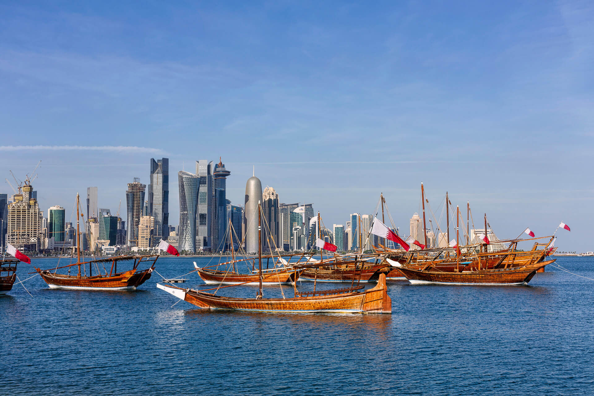 Traditional Arabic Dhow boats with Qatar flags in Doha